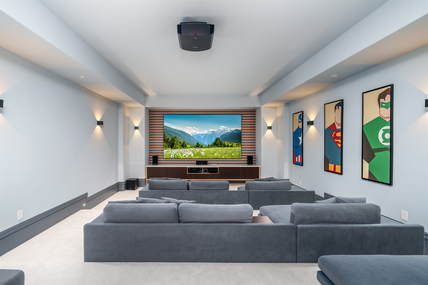 Private cinema room with ceiling projector, slatted timber screen wall and lounge seating