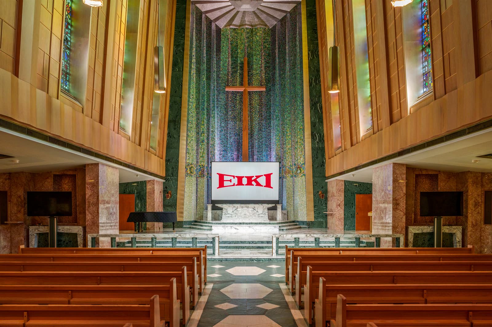 A cathedral sanctuary with a large projection screen at the altar